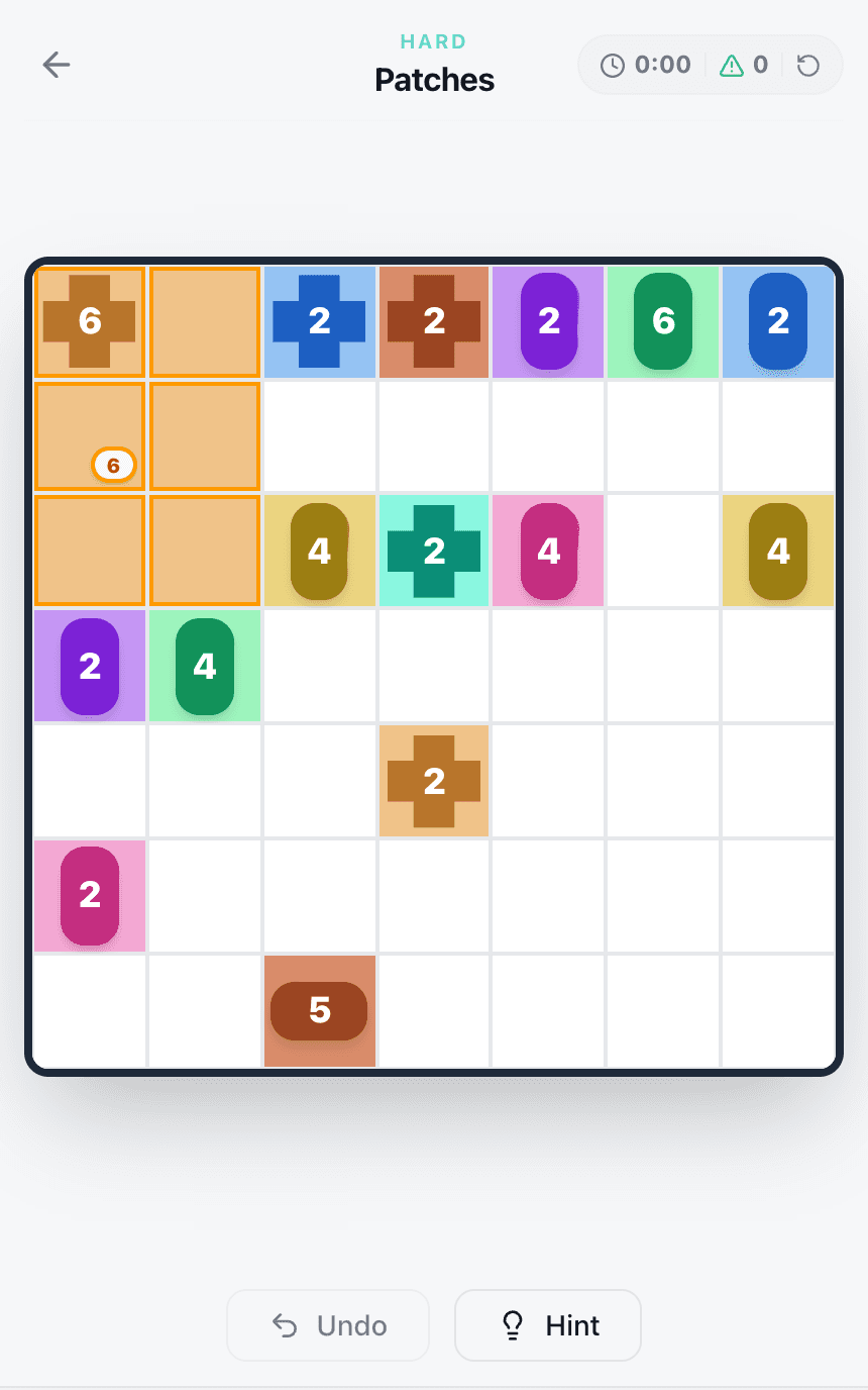 A 7×7 Patches board with a 6 on a plus-shaped Any badge in the top-left corner, being covered by a rectangle two cells wide and three cells high.